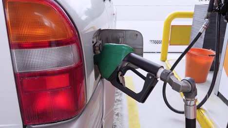 gas pump filling car tank at station