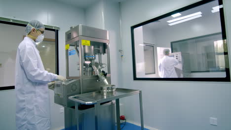 scientists or technicians observing experiment with liquid samples into analyzer medical machine. scientist works with modern medical equipment in pharmaceutical laboratory