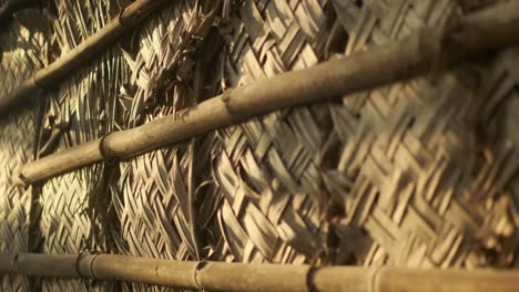 close up of interwoven coconut palm leaves used in a structure