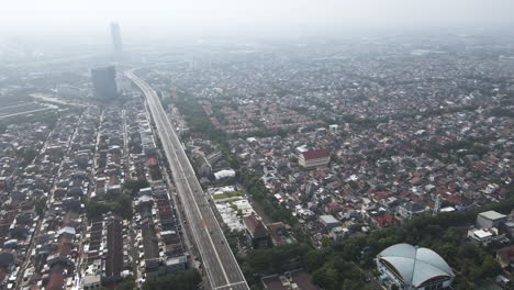 panoramic view over roofs of houses and buildings in jakarta, capital of indonesia - aerial drone shot
