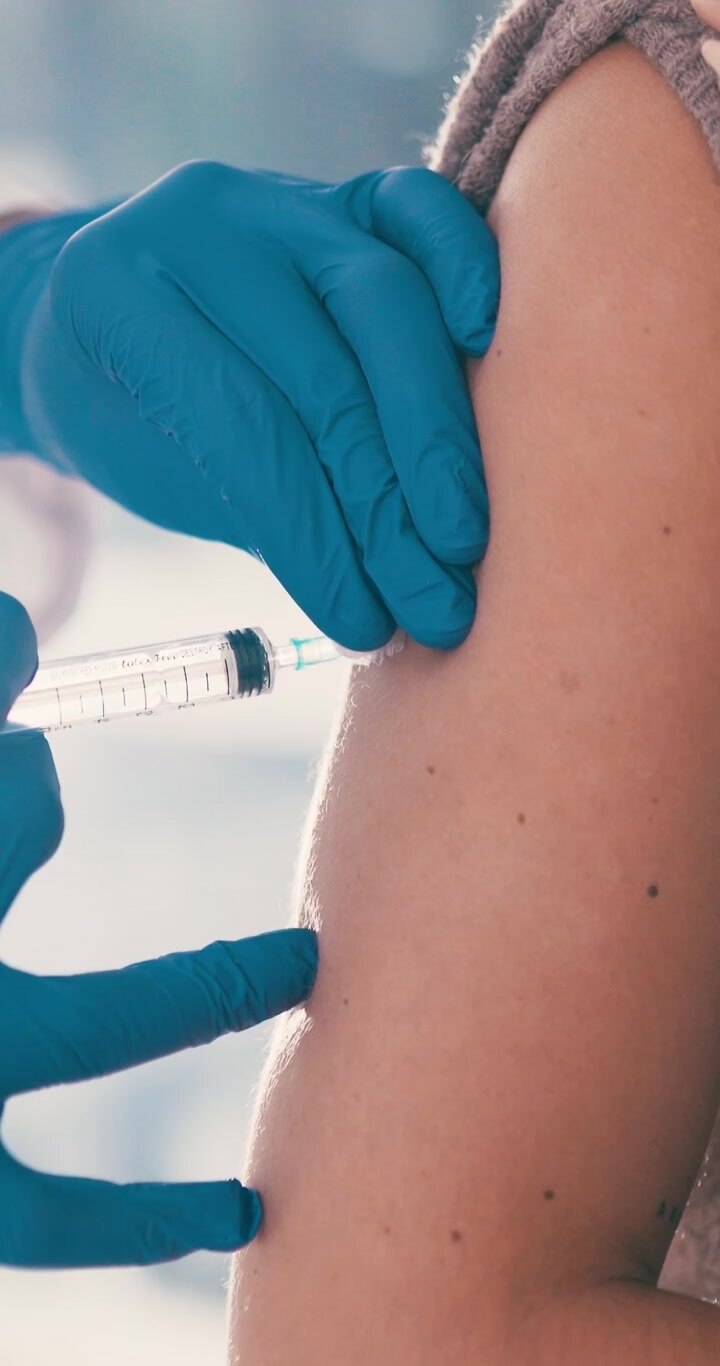 Medical Professional Administering Vaccine Injection to Patient Arm