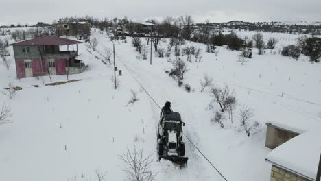 grayder plows snow on the road