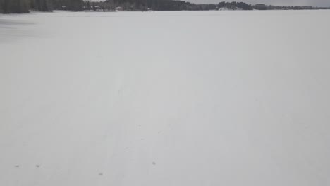 river leading to frozen lake in ely, st