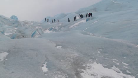 a group of explorers move across a glacier