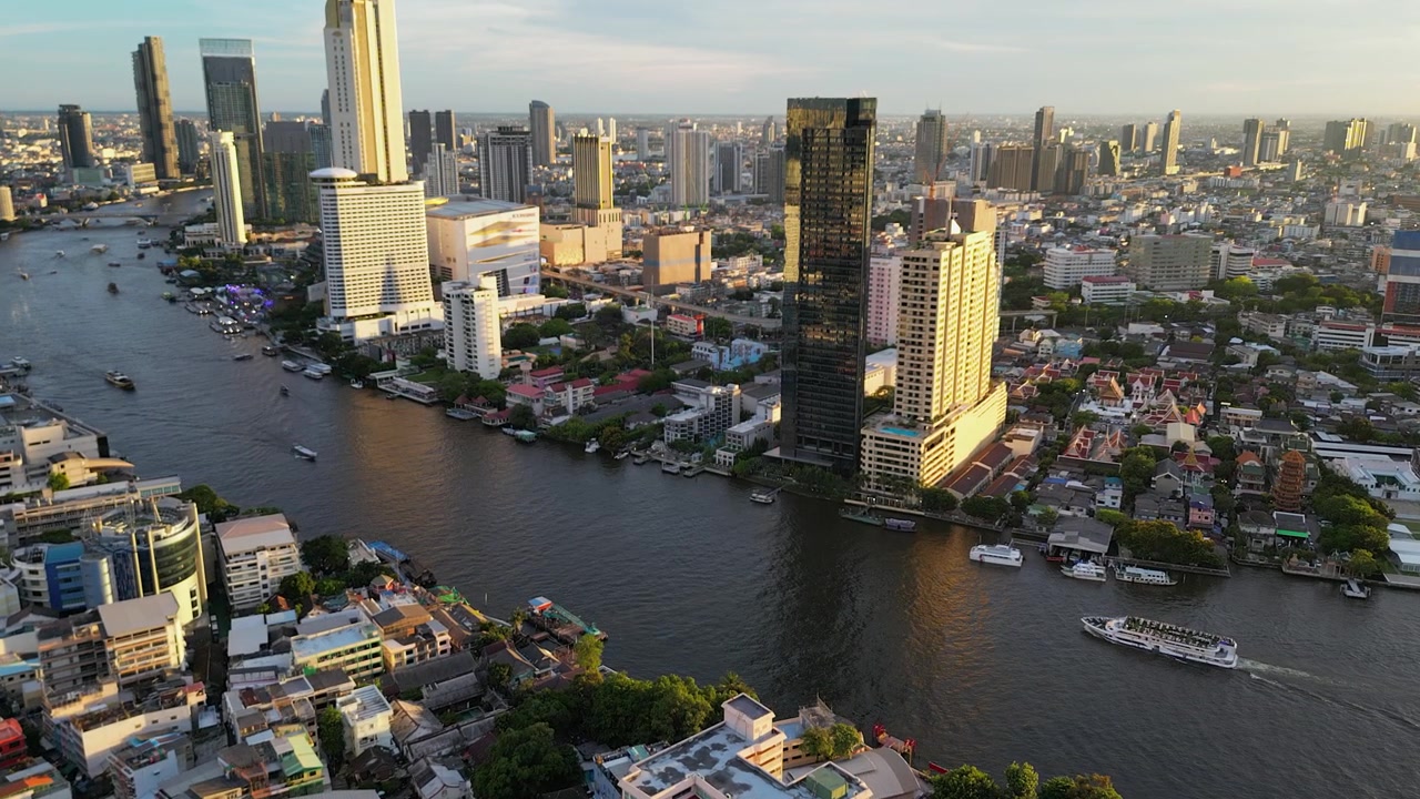 Tour boats take tourists on Chao Phraya River in golden hour Bangkok