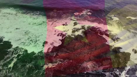 Digital-composition-of-waving-cameroon-flag-against-aerial-view-of-sea-waves