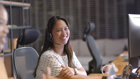 Biracial-woman-smiles-while-working-in-a-business-office