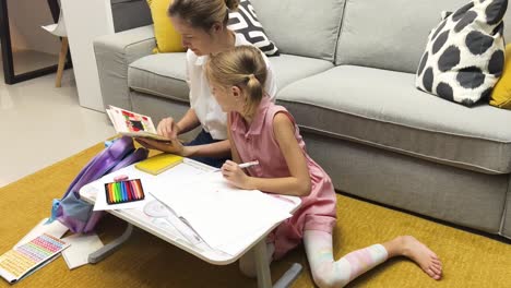 mother and daughter doing homework/art together at home