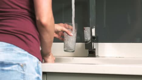 woman  serving a glass of water