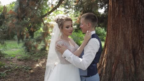 newlyweds. caucasian groom with bride in the park. wedding couple. happy family