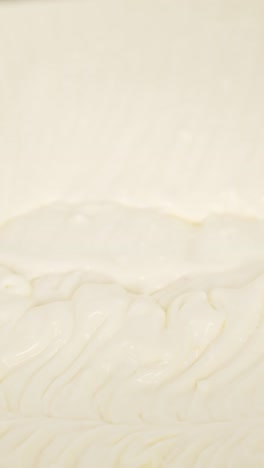 close-up vertical shot of mixing cream dough, a crucial step in preparing tiramisu dessert.