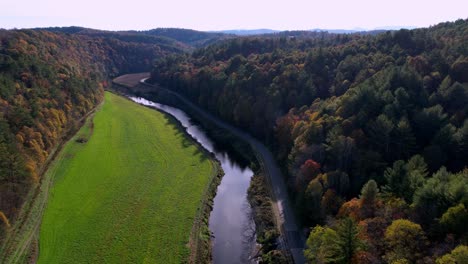 aerial high above the new river in fall tilt up