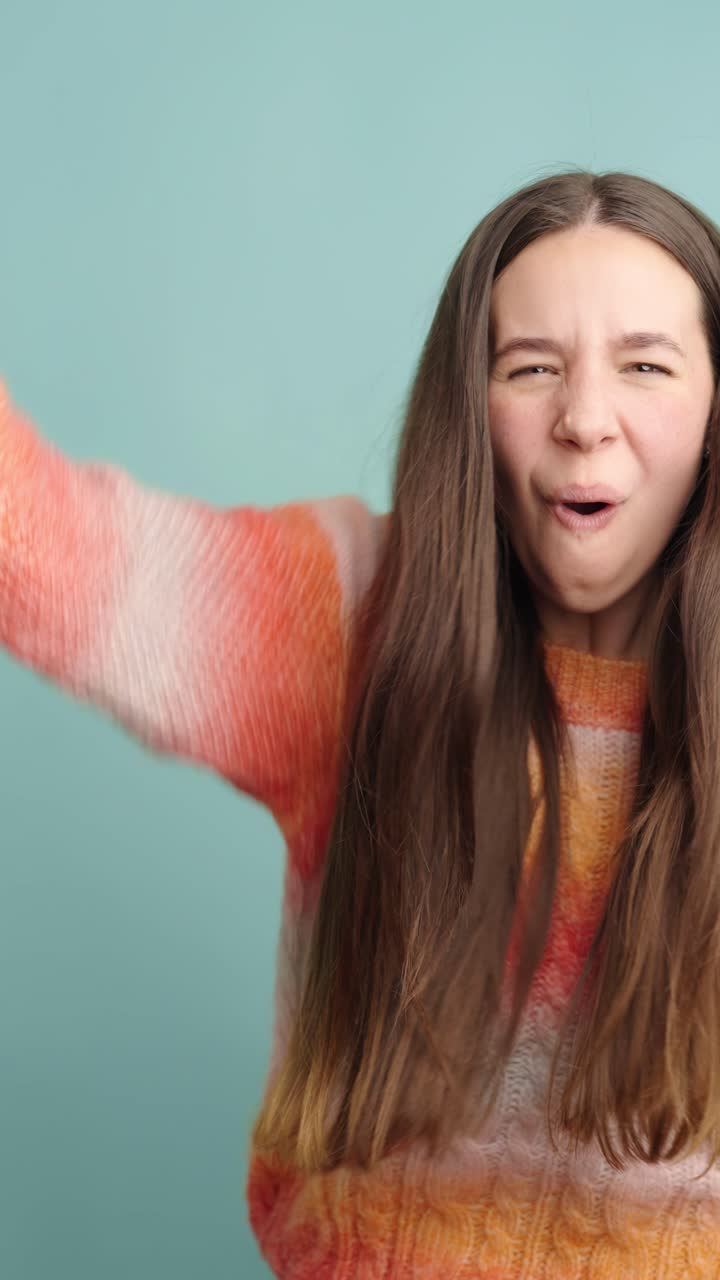 Young woman expressing joy with enthusiastic dance moves