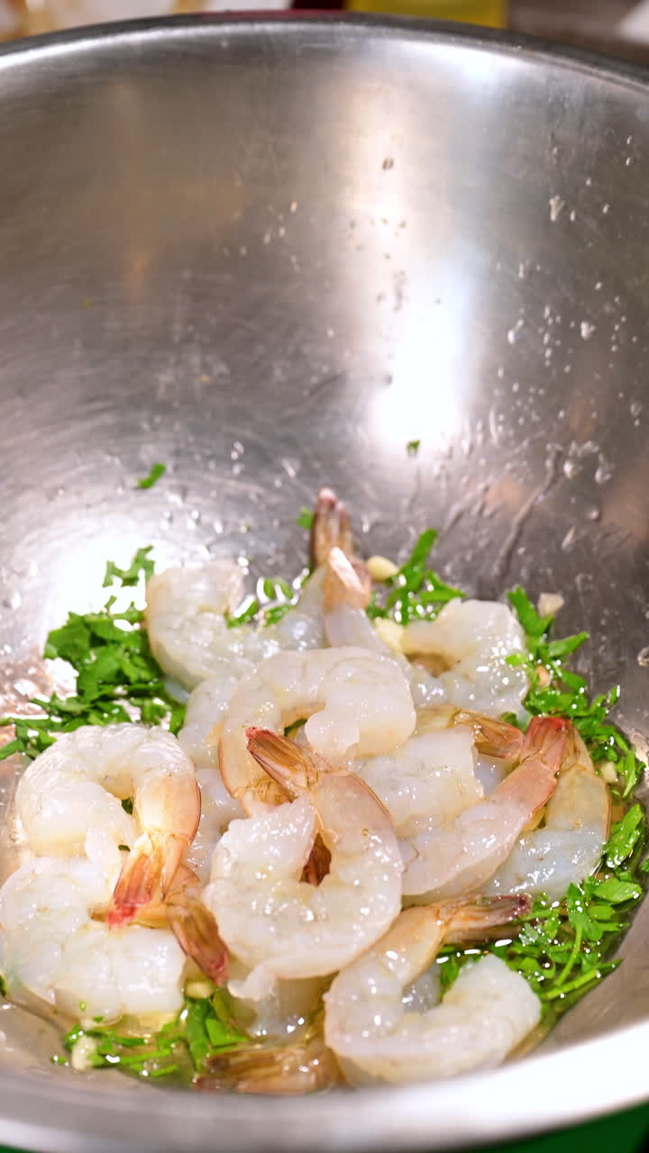 Raw shrimp with parsley in bowl. Fresh raw shrimp with parsley and garlic prepared in a bowl before cooking