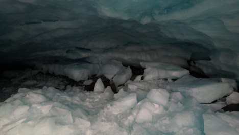 Spectacular-drone-view-of-high-mountain-peak,-collapsed-glacial-cave-and-alpine-scenery-of-beautiful-New-Zealand