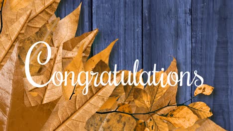 Animation-of-congratulations-text-over-leaves-on-wooden-background