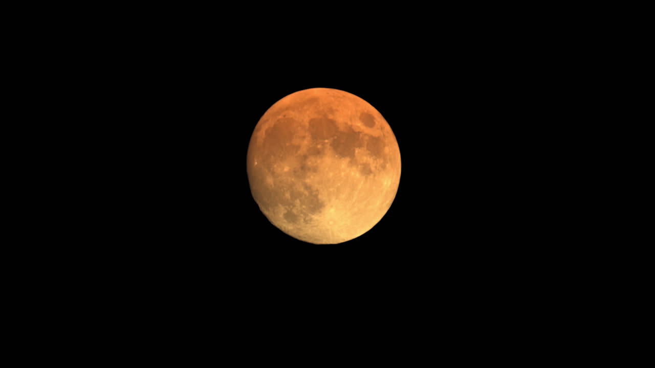 Closeup Isolated Shot Of Full Blood Moon Illuminated In Night Sky