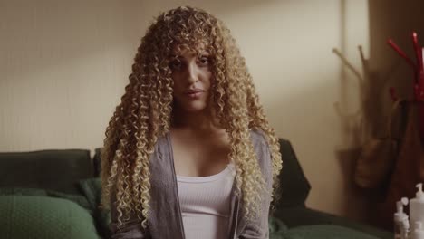 portrait of a young woman with long curly blonde hair