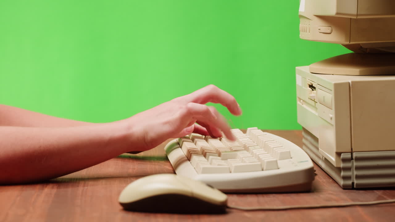 Person Typing on Vintage Computer