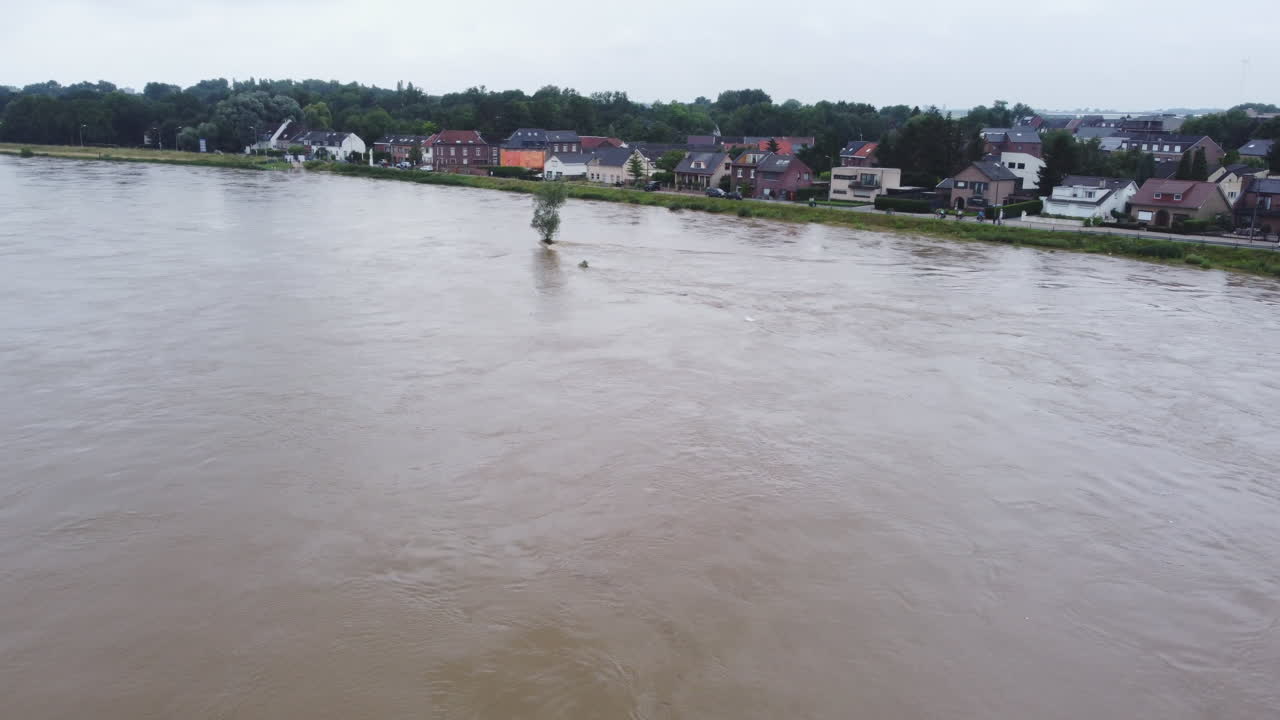 Aerial flying forward over flooding of Meuse river in Smeermaas, Belgium