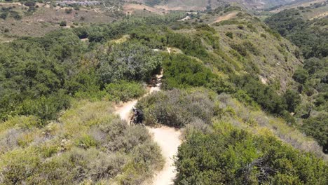 Drone-shot-of-mountain-biker-on-mountain-trail