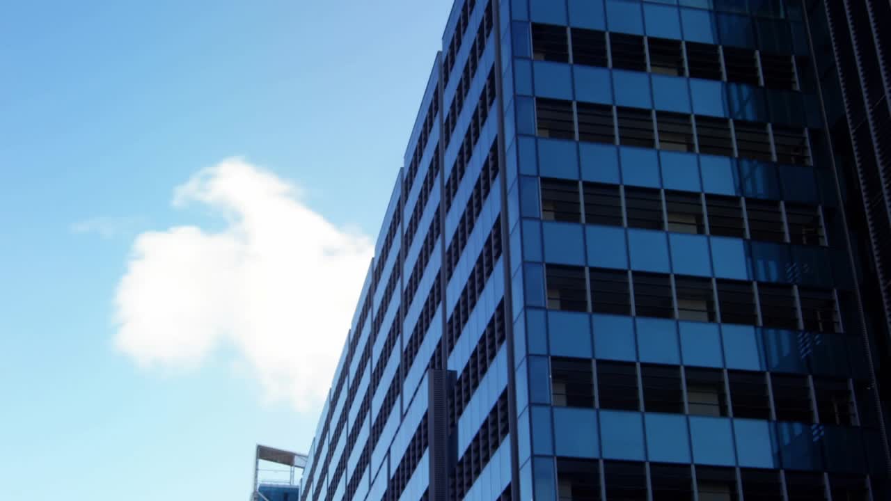 Faint map outline appearing, HUD nodes flowing right and mapping glass tower, showing global data