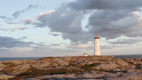 Cloudy-Sunset-Sky-Over-Lille-Torungen-Lighthouse-In-Arendal,-Norway---aerial-drone-shot