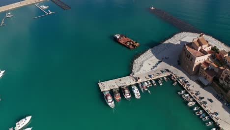 aerial birds eye view over castellammare del golfo port with slow right view of castello arabo normanno