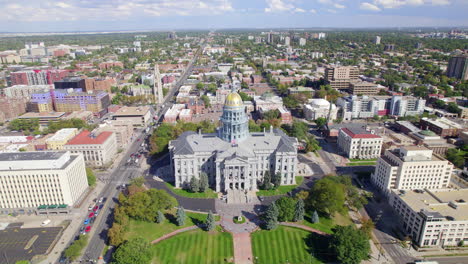 drone reversing away from the colorado state government capitol building in downtown denver ,colorado , usa near civic center park