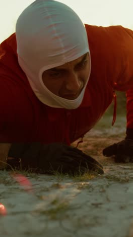 suffocating astronaut crawls lying on the ground in planet with toxic atmosphere