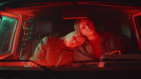 portrait of romantic couple in car with red light