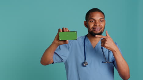 radiant healthcare specialist holding chroma key phone