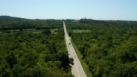 Blue-Car-On-A-Road-Trip-On-Countryside-Of-Istria,-Croatia-During-Summer