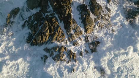 Foamy-Crashing-Waves-Over-Rocky-Outcrops-In-Summer