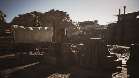 old western town setting with wagons and crates under bright daylight