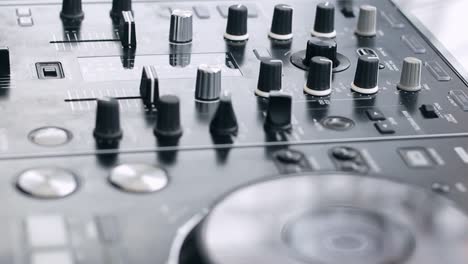 close up shot dj hand live perform; play and mixing music move slidder fadder and switch the knob on dj mixer equipment controller; dj daytime party