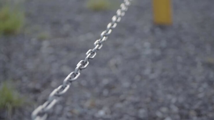 Isolated strong metal chain sways in breeze