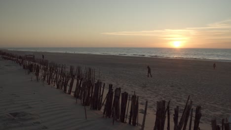 wide shot of the sunset on the beach of sylt with people walking by