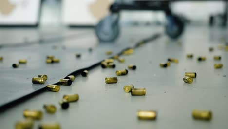 scattered empty gun cartridges on shooting range floor