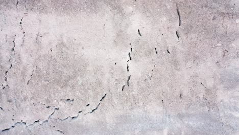 high aerial top down shot over desert landscape showing texture and cracks in the earth