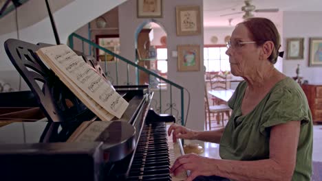 anciana tocando un piano de cola en su casa