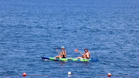 two tourists kayaking in sorrento, naples, italy