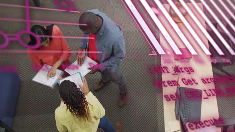 animation of graphs, globe, computer language, overhead view of diverse coworkers discussing reports