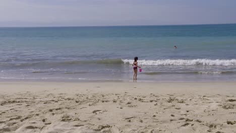 a girl plays and enjoys a sunny day at a mexican beach