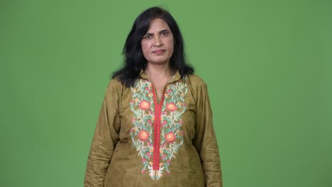 mature beautiful indian woman wearing traditional clothes with arms crossed