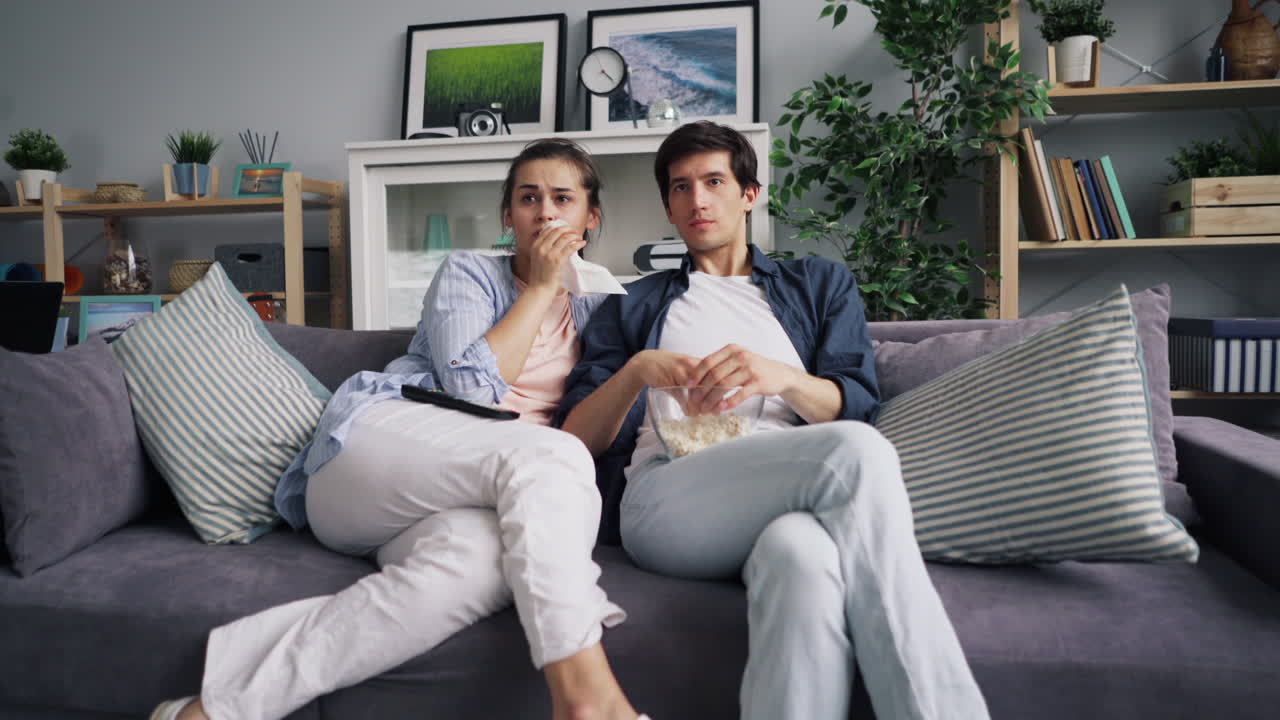 Couple Relaxing on Sofa Watching Movie