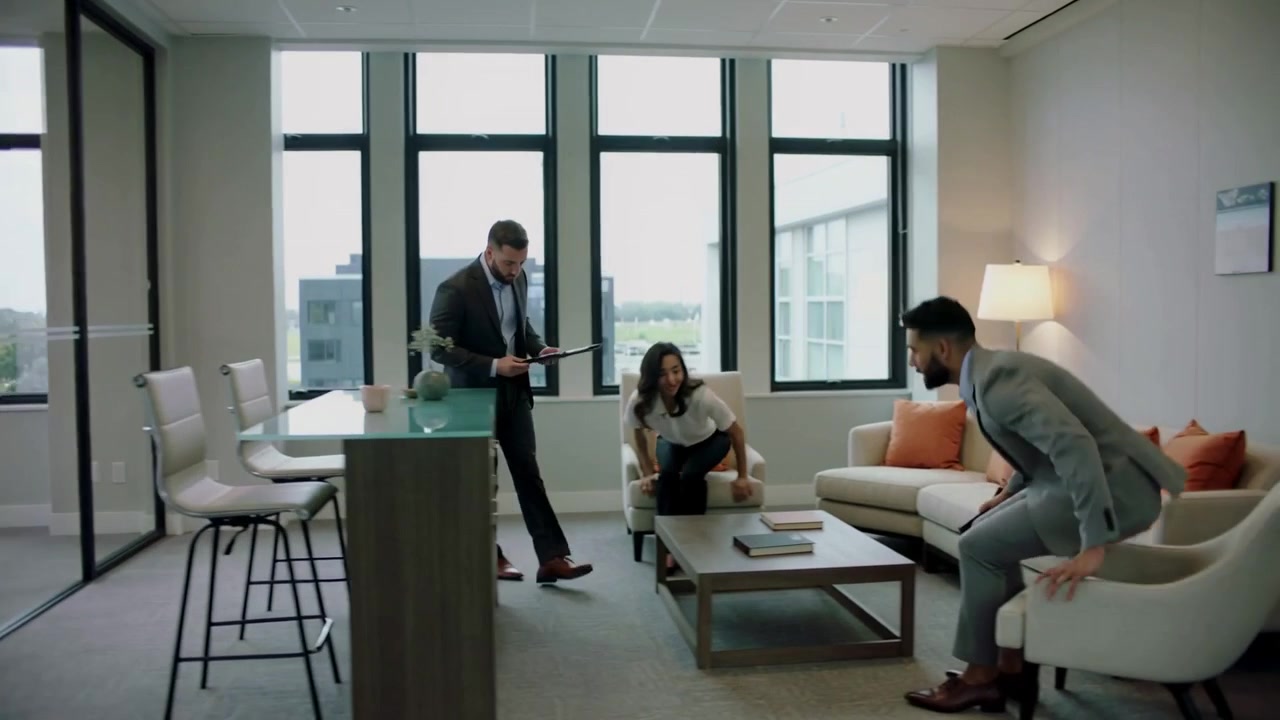 Walking man in gray suit consulting tablet from boardroom into lounge preparing meeting, copy space