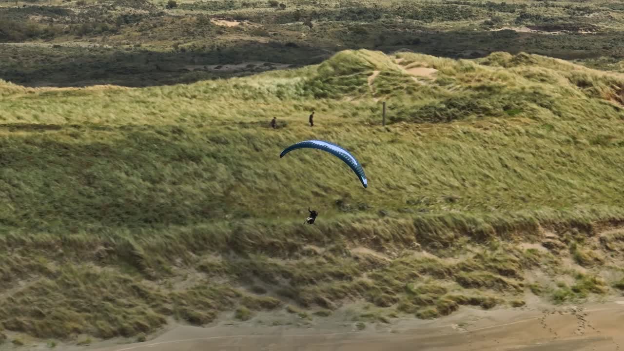 Extreme Paragliding, Sunny Day Long Shadows, Wide Aerial Tracking Shot Costal, Langevelderslag Beach, Netherlands
