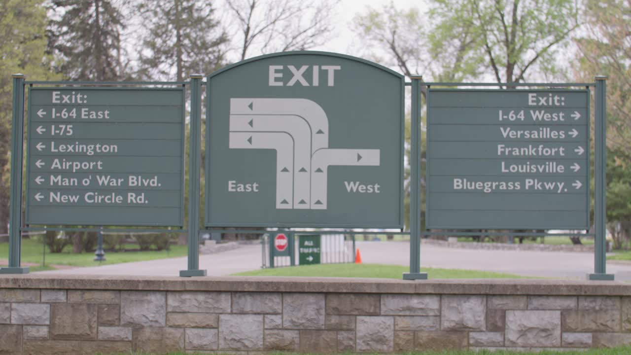 Exit sign outside Keenland horse racing track in Lexington, Kentucky with stable video.