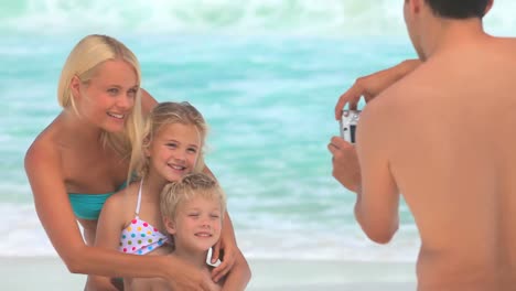 man taking a photo of his wife and children